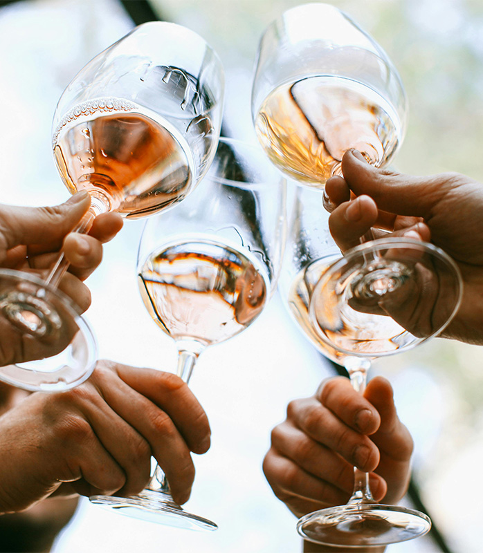 People toasting with glasses or white and rosé wine